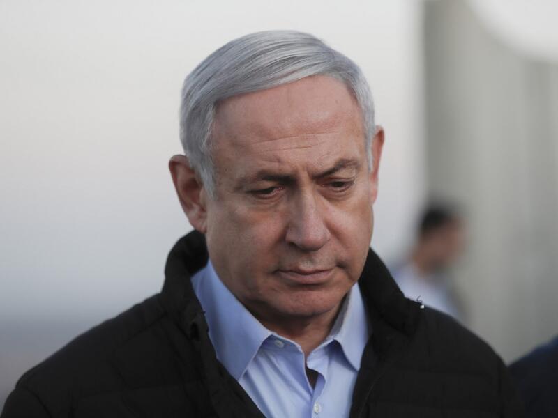 Israel's Prime Minister Benjamin Netanyahu looks on during a visit to an army base in the Israeli-annexed Golan Heights overlooking Syrian territory, on November 24, 2019. ATEF SAFADI / POOL / AFP