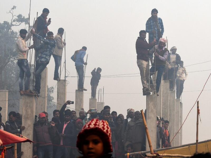 People watch Hindu devotee slaughter buffalos as offering during the Gadhimai Festival in Bariyarpur on December 3, 2019. Thousands of Hindu devotees gathered in southern Nepal for a festival believed to be the world's biggest ritual animal slaughter, despite court orders and calls by animal activists to end the event. The sacrifices take place every five years in Bariyarpur village close to the Indian border, in honour of the Hindu goddess of power. Prakash MATHEMA / AFP