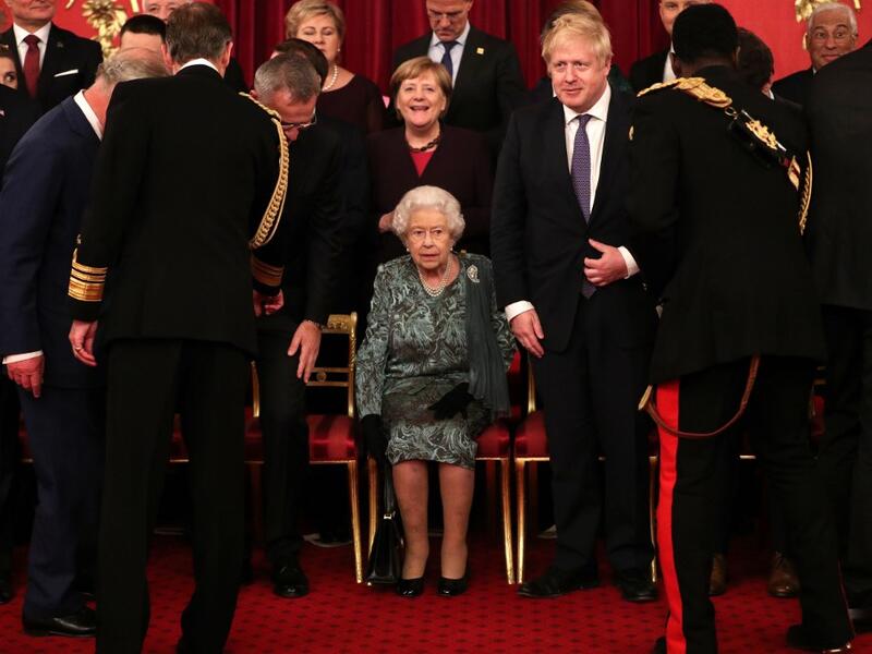 Britain's Queen Elizabeth II (C) sits as leaders come together at Buckingham Palace in central London on December 3, 2019, for a group picture to mark 70 years of the alliance ahead of the NATO alliance summit. NATO leaders gather Tuesday for a summit to mark the alliance's 70th anniversary but with leaders feuding and name-calling over money and strategy, the mood is far from festive. Yui Mok / POOL / AFP