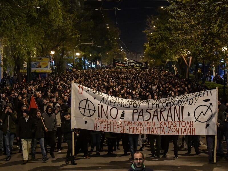 People carry a giant banner reading "They shall not pass" as they march in central Athens on December 6, 2019 after a rally commemorating the death of a 15-year-old teenager, who was fatally shot by a police officer in 2008. (AFP/ File Photo)