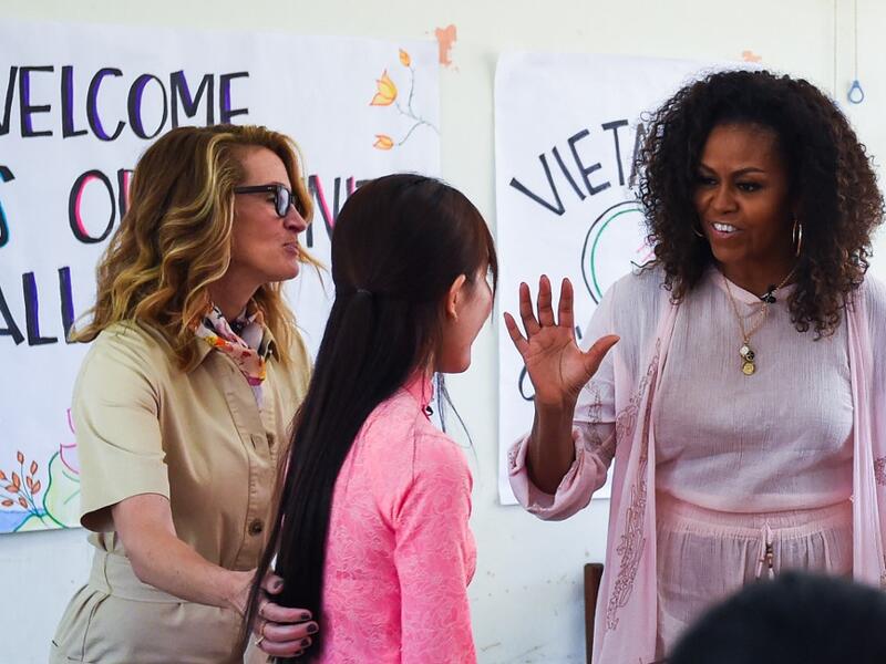 Former US First Lady Michelle Obama (R) and actress Julia Roberts (L) meet Vietnamese students in Can Giuoc district, Long An province on December 9, 2019. Michelle Obama and Julia Roberts visit to promote girls' education in Vietnam. Nhac NGUYEN / AFP