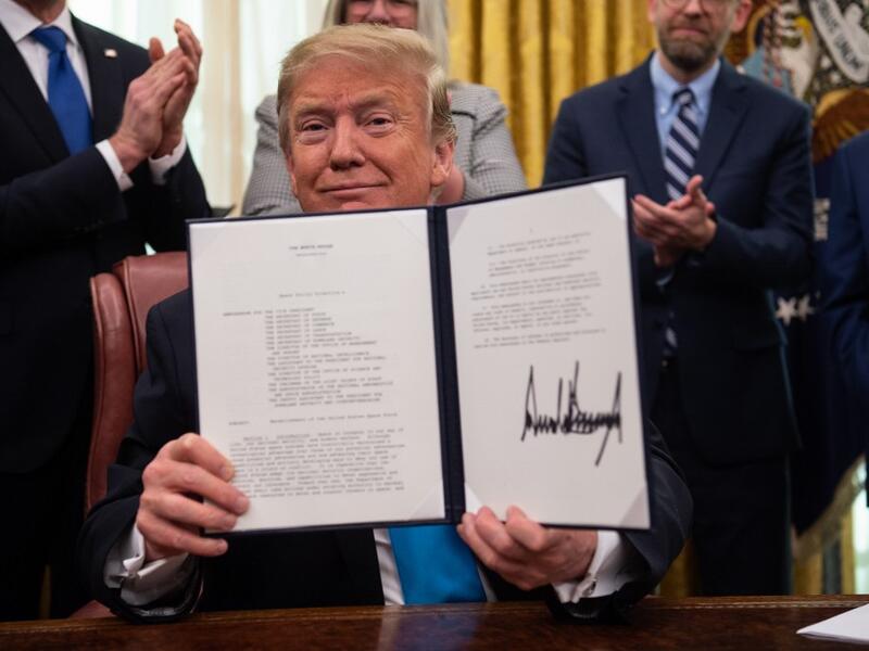 In this file photo taken on February 19, 2019, US President Donald Trump shows his signature on the Space Policy Directive-4 (SPD-4) at the White House in Washington, DC (AFP)