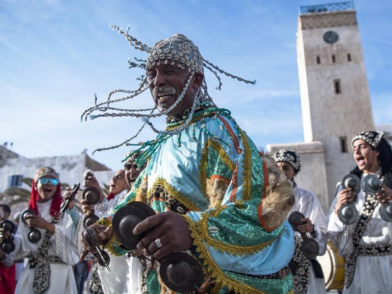 A Gnawa traditional group performs in the city of Essaouira on December 14, 2019, to celebrate the decision of adding the Gnawa culture to UNESCO's list of Intangible Cultural Heritage of Humanity. FADEL SENNA / AFP