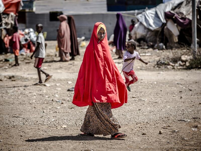 A girl walks towards her tent at a displacement camp for people affected by intense flooding in Beledweyne, Somalia, on December 14, 2019. The rains have inundated big areas surrounding Beledweyne area forcing thousands of people to leave their houses and look for humanitarian assistance while living in displacement camps. Due to climate change and human activities, cycles of floods and droughts have become more recurrent and completely unpredictable in Somalia exposing hundreds of thousands of people every