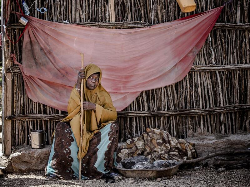 A displaced woman sits under the shadow at the place where she sleeps at a displacement camp in Beledweyne, Somalia, on December 14, 2019. The rains have inundated big areas surrounding Beledweyne area forcing thousands of people to leave their houses and look for humanitarian assistance while living in displacement camps. Due to climate change and human activities, cycles of floods and droughts have become more recurrent and completely unpredictable in Somalia exposing hundreds of thousands of people every