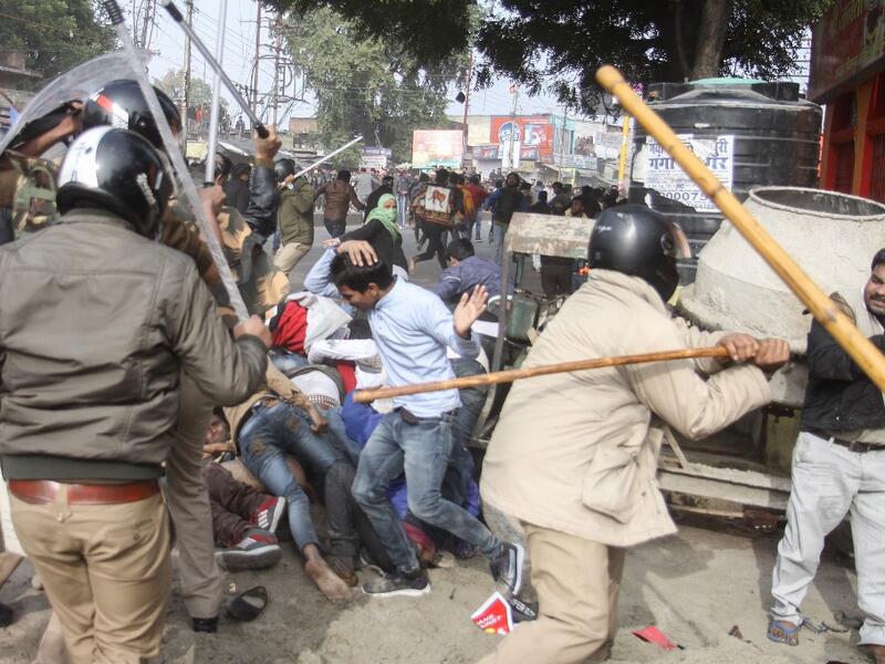 In this file picture taken on December 19, 2019, police with sticks locally known as "lathi" beat protesters during a demonstration against India's new citizenship law in Lucknow. As Indian protests against a new citizenship law have intensified, so has use of "lathis", sturdy sticks used to whack, thwack and quell dissent since British colonial times -- to sometimes deadly effect. STR / AFP