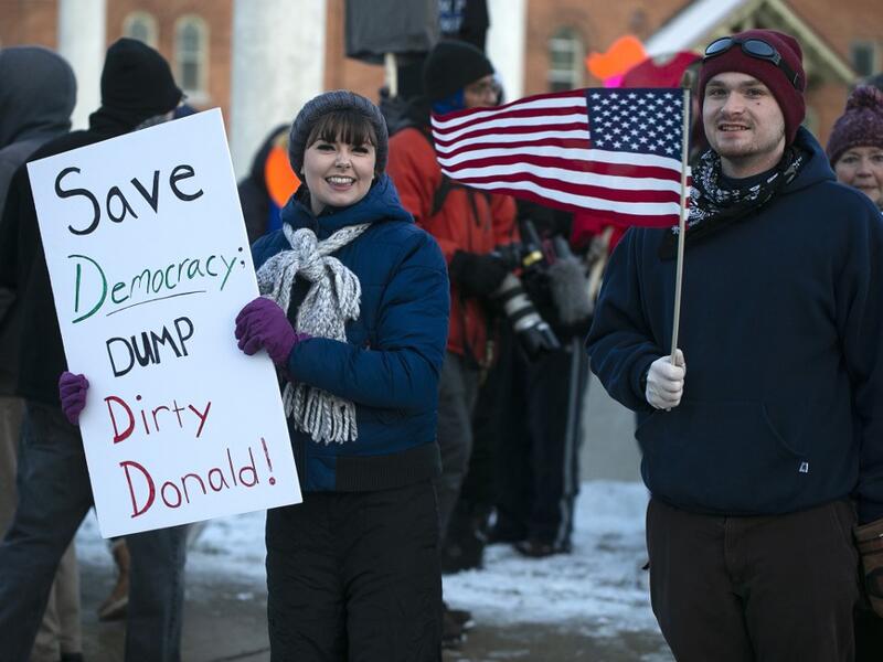 Anti-Trump protesters gather at Monument Park on December 18, 2019 in Battle Creek, Michigan. The full House of Representatives is voting on two articles of impeachment against President Donald Trump. Nuccio DiNuzzo/Getty Images/AFP