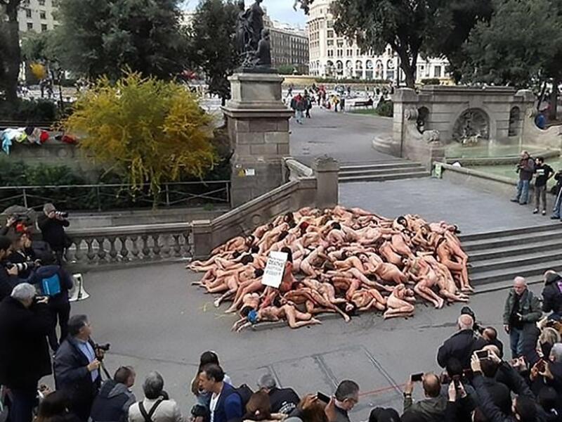 The protest consisted of dozens of activists lying on the ground while covered in fake blood as a sitting woman holding a sign shouted out 'suffering is not elegant'. (CEN/ AnimaNaturalis)