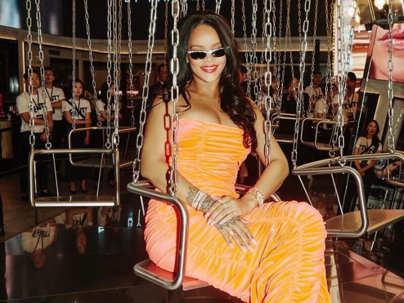 Rihanna's luxuriant dark tresses are down, and she wears a classic pop of red color on her lips (source: @badgalriri Instagram)