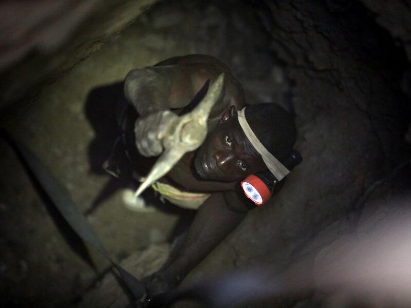 A gold miner works underground in Anka near Gusau, on December 4,2019. For generations, the mineral-rich earth of Nigeria's Zamfara state has provided families living here with a way to make ends meet. But in recent years their trade has become increasingly unsafe. The mines lie within the reach of heavily-armed groups -- dubbed "bandits" by the local authorities -- that have been terrorising this remote region.  Kola Sulaimon / AFP