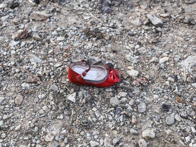 A child's shoe is pictured on January 8, 2020 at the scene of a Ukrainian airliner that crashed shortly after take-off near Imam Khomeini airport in the Iranian capital Tehran. Search-and-rescue teams were combing through the smoking wreckage of the Boeing 737 flight from Tehran to Kiev but officials said there was no hope of finding anyone alive. The vast majority of the passengers on the Ukraine International Airlines flight were non-Ukrainians, including 82 Iranians and 63 Canadians, officials said. Born