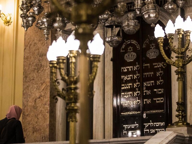 A Muslim woman visits the newly renovated Eliyahu Hanavi synagogue in the northwestern Egyptian city of Alexandria on January 10, 2020, on the day of its inauguration. The synagogue, boasting green and violet stained glass windows and towering marble columns, was built in its current form in 1850 by an Italian architect on top of the original edifice dating back to 1354. Khaled DESOUKI / AFP