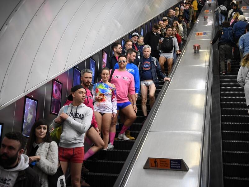 People use an escalator as they take part in the annual 'No Trousers On The Tube Day' (No Pants Subway Ride) on the London Underground in central London on January 12, 2020.  (AFP/ File Photo)