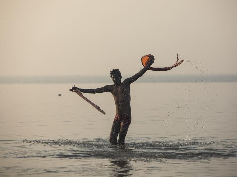 A Hindu devotee takes a holy dip in the Bay of Bengal during the Gangasagar Mela, at Sagar Island, some 150 kilometres south of Kolkata on January 14, 2020. Xavier GALIANA / AFP
