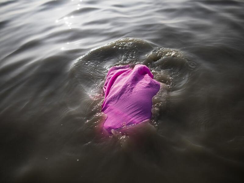 A Hindu devotee takes a holy dip in the Bay of Bengal during the Gangasagar Mela, at Sagar Island, some 150 kilometres south of Kolkata on January 14, 2020. XAVIER GALIANA / AFP
