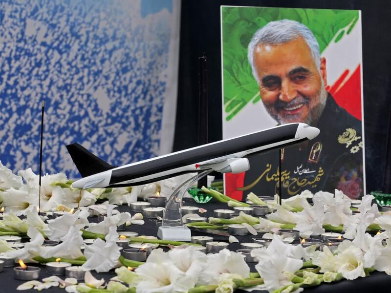 A poster of slain military commander Qasem Soleimani is seen at a memorial for the victims of the Ukrainian plane crash, in University of Tehran on January 14, 2020. Iran announced its first arrests over the shooting down of a Ukrainian airliner last week, as it struggles to contain the fallout from the disaster that sparked three days of protests. ATTA KENARE / AFP