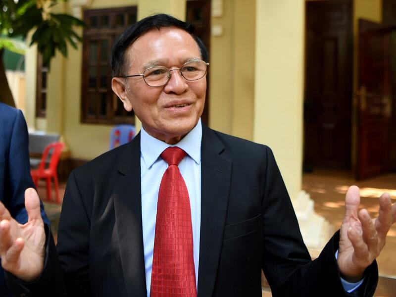 Kem Sokha, former leader of the now-banned Cambodia National Rescue Party (CNRP), speaks to media as he departs his residence for the Phnom Penh municipal court for his trial on January 15, 2020. The treason trial of Cambodian opposition leader Kem Sokha opened on January 15, more than two years after his arrest in a case decried by his family as a "farce" and described by the US as politically motivated.  TANG CHHIN Sothy / AFP
