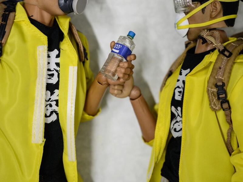 This picture taken on January 14, 2020 shows 1:6 scale action figures depicting characters involved in the Hong Kong protests, in Hong Kong. Intricately detailed Hong Kong protester figurines have become the latest must-have collectables as toy stores recreate the pro-democracy movement's street battles with police in their shop displays.  Philip FONG / AFP