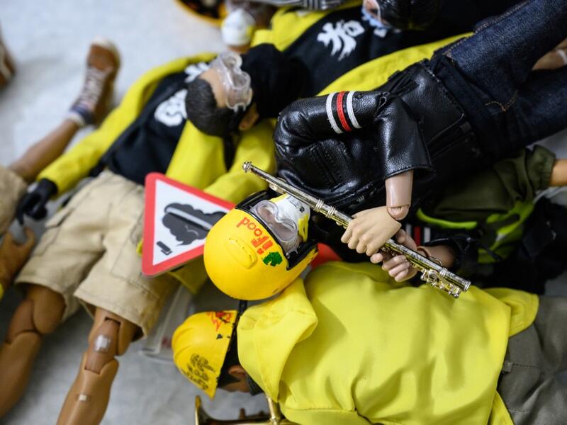 This picture taken on January 14, 2020 shows 1:6 scale action figures depicting characters involved in the Hong Kong protests, in Hong Kong. Intricately detailed Hong Kong protester figurines have become the latest must-have collectables as toy stores recreate the pro-democracy movement's street battles with police in their shop displays.  Philip FONG / AFP