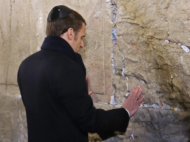 French President Emmanuel Macron prays at the Western Wall, Judaism's holiest prayer site, in Jerusalem's Old City on January 22, 2020. (AFP/ File Photo)