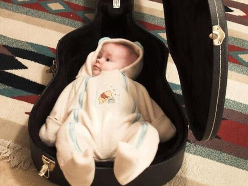 A baby was placed into a guitar case as the 'playing Ghosn' craze swept Japan. The fugitive tycoon escaped the country inside an audio equipment case (Twitter)