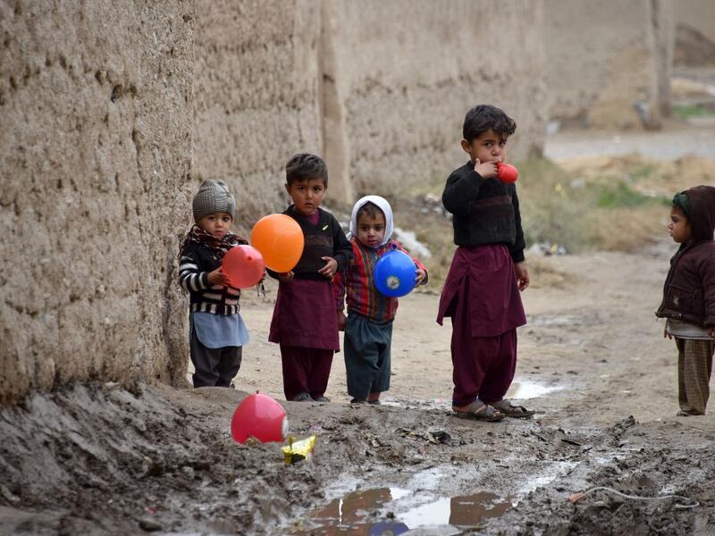Children play with balloons along a street in Kandahar Province on January 28, 2020. JAVED TANVEER / AFP
