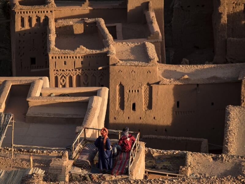 Men stand atop the Kasbah (ancient fortress) of Ait-Ben-Haddou, where scenes depicting the fictional city of Yunkai from the hit HBO television series "Game of Thrones" were filmed, about 32 kilometres northwest of the city of Ouarzazate south of Morocco's High Atlas mountains on January 27, 2020. FADEL SENNA / AFP