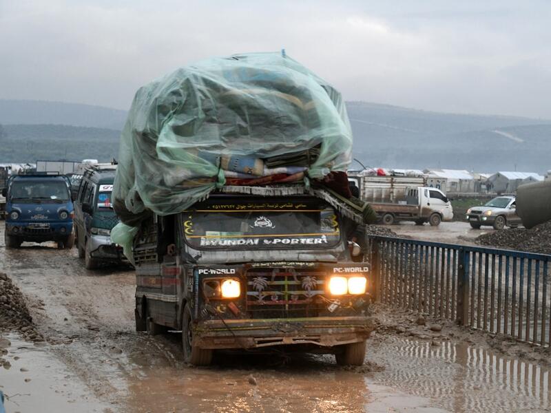 Syrians displaced from the south of Idlib province travelling in vehicles loaded with furniture and other belongings and fleeing from advancing government forces arrive at a camp for the internally displaced near Dayr Ballut, near the Turkish border in the rebel-held part of Aleppo province in the country's northwest on February 4, 2020. Rami al SAYED / AFP