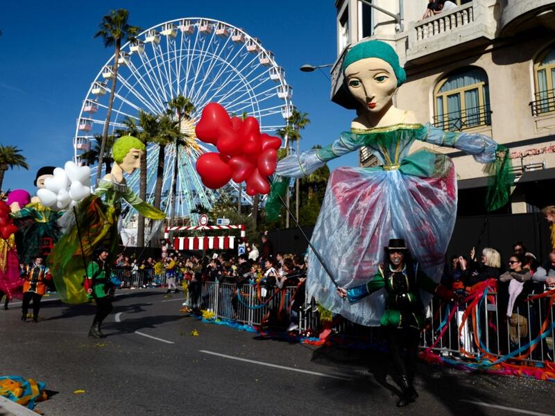 Participants take part in the 136th Nice Carnival parade which celebrates this year the 'Fashion King' in Nice, southeastern France, on February 15, 2020. The carnival runs from February 15 to February 29, 2020. VALERY HACHE / AFP