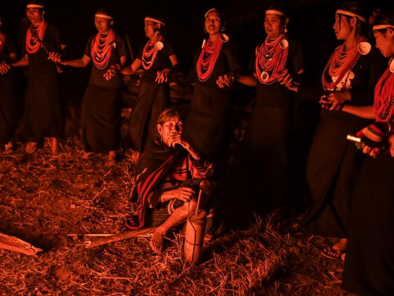 This photo taken on February 6, 2020 shows Naga tribeswomen taking part in an overnight ceremony to bless the harvest in Satpalaw Shaung village, Lahe township in Myanmar's Sagaing region. A haunting refrain pierces the night as the tribeswomen of the Gongwang Bonyo, among the most isolated people in Myanmar, dance around a campfire to bless the harvest ahead. Ye Aung THU / AFP
