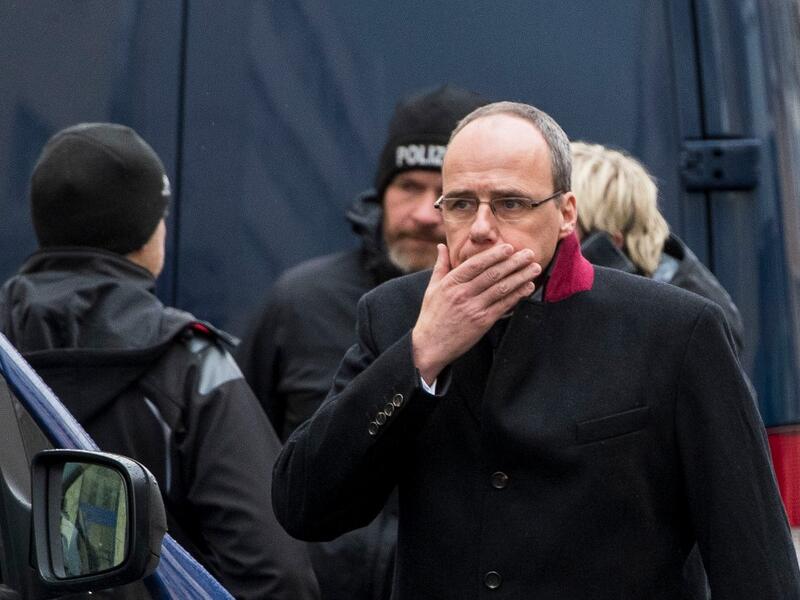 Hesse state Interior Minister Peter Beuth reacts as he arrives at one of the bar target in a shooting at the Heumarkt in the centre of Hanau, near Frankfurt am Main, western Germany, on February 20, 2020, where at least nine people were killed in two shootings late on February 19, 2020. The suspect in two shootings in Germany that killed at least nine people was found dead at home, police said on February 20, 2020. At least nine people were killed in two shootings late on February 19 in Hanau, near the Germ