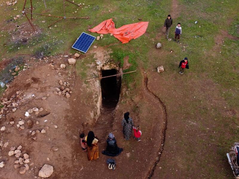 This picture taken on February 23, 2020 shows an aerial view of a solar panel placed outside the entrance of an underground shelter where several families of internally displaced Syrians from Aleppo and Idlib provinces are taking refuge, in the village of Taltunah about 15 kilometres northwest of Idlib in the northwestern Idlib province. Aref TAMMAWI / AFP