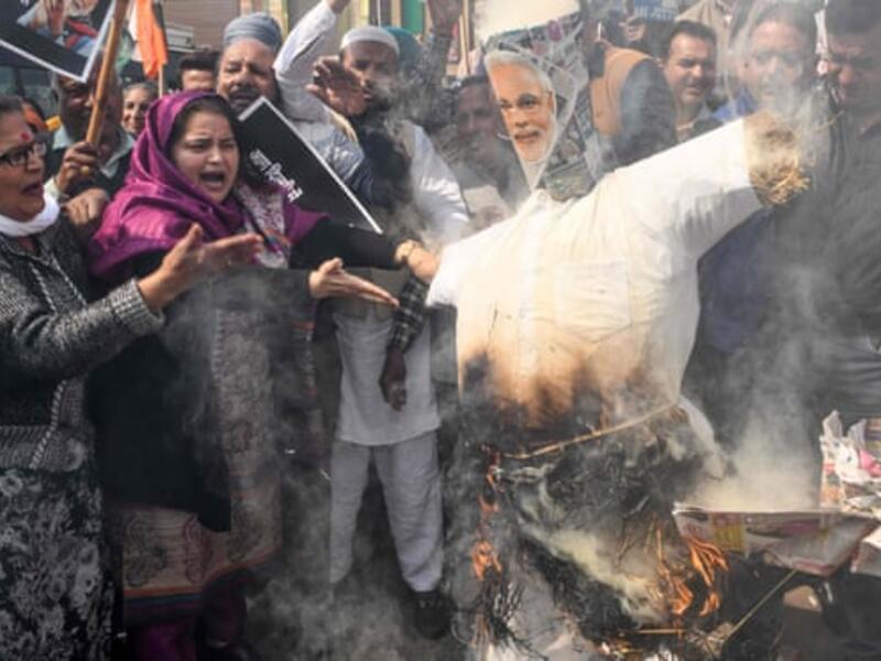  Congress party supporters in Amritsar burn an effigy of Narendra Modi during a demonstration to protest against the violence occurring in Delhi. Photograph: Narinder Nanu/AFP via Getty Images
