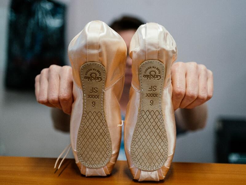 An employee of Grishko company produces pointe shoes in the company's Moscow workshop on February 25, 2020. Born in the chaos of the collapse of the Soviet Union, the Grishko family business has emerged among the top makers in the world of dance shoes, notably classic ballet pointe shoes, worn on the world's great stages. Dimitar DILKOFF / AFP