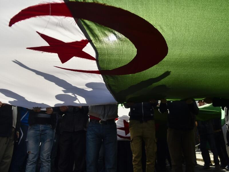 Algerian demonstrators wave the national flag during a demonstration in the capital Algiers, on February 28, 2020. Mass protests erupted in Algeria a year ago last Saturday, in response to President Abdelaziz Bouteflika announcing he intended to run for a fifth term after 20 years in power -- despite being debilitated by a 2013 stroke. RYAD KRAMDI / AFP