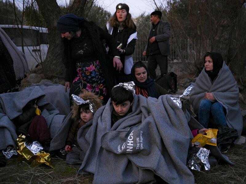 Migrants sit on a beach covered with blanket near Skala Sykamineas on the Greek Lesbos island after crossing the Aegean sea between Turkey and Greece on March 1, 2020. Greece has blocked nearly 10,000 migrants trying to enter at the Turkey border over the past 24 hours, a Greek government source said Sunday. "From 0600 (0400 GMT) Saturday morning to 0600 Sunday morning, 9,972 illegal entrances have been averted in the Evros area," a government source said, referring to the northeastern region along the Turk