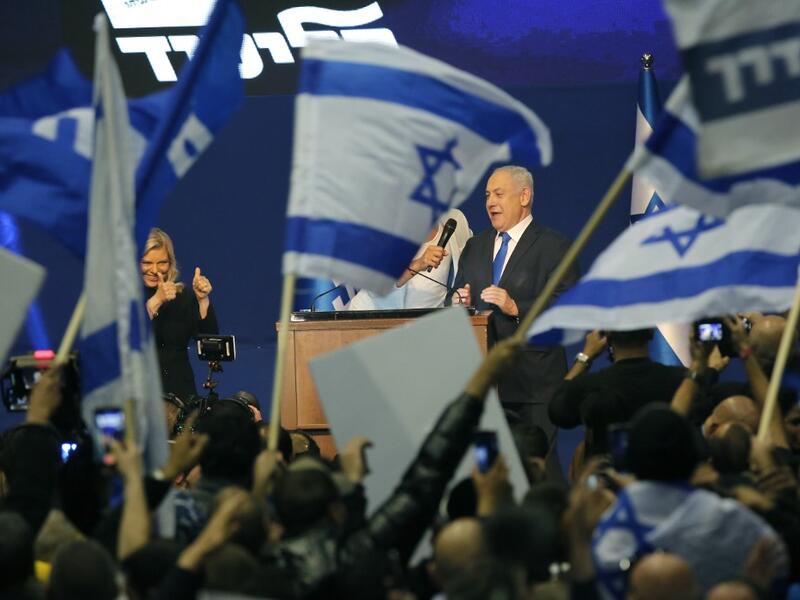 Israeli Prime Minister Benjamin Netanyahu and his wife Sara address supporters at the Likud party campaign headquarters in the coastal city of Tel Aviv early on March 3, 2020, after polls officially closed. Netanyahu claimed "a giant victory" in elections on March 3, boasting that his right-wing Likud party had defied "all expectations" in the country's third vote in less than a year. After exit polls by three networks forecast that Likud and its allies were on track to win 59 parliamentary seats -- two sho