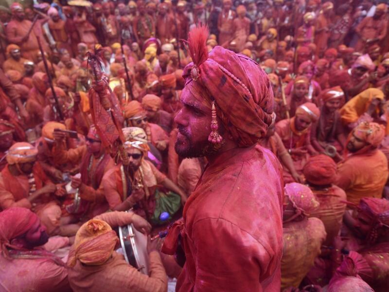 Hindu devotees celebrate Holi, the spring festival of colours, during a traditional gathering at a temple in Nandgaon village in Uttar Pradesh state on March 5, 2020. Holi is observed in India at the end of the winter season on the last full moon of the lunar month. Money SHARMA / AFP