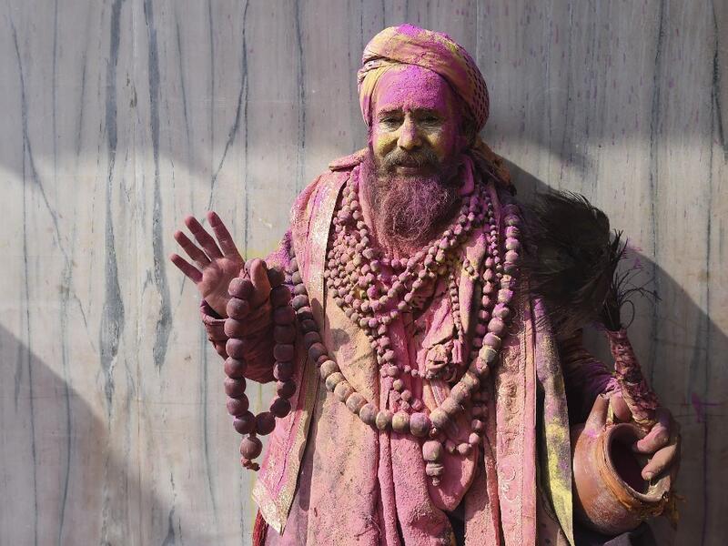 A sadhu (Hindu holy man) gestures to the camera during Holi celebrations, the spring festival of colours, in Nandgaon village in Uttar Pradesh state on March 5, 2020. Holi is observed in India at the end of the winter season on the last full moon of the lunar month. Money SHARMA / AFP
