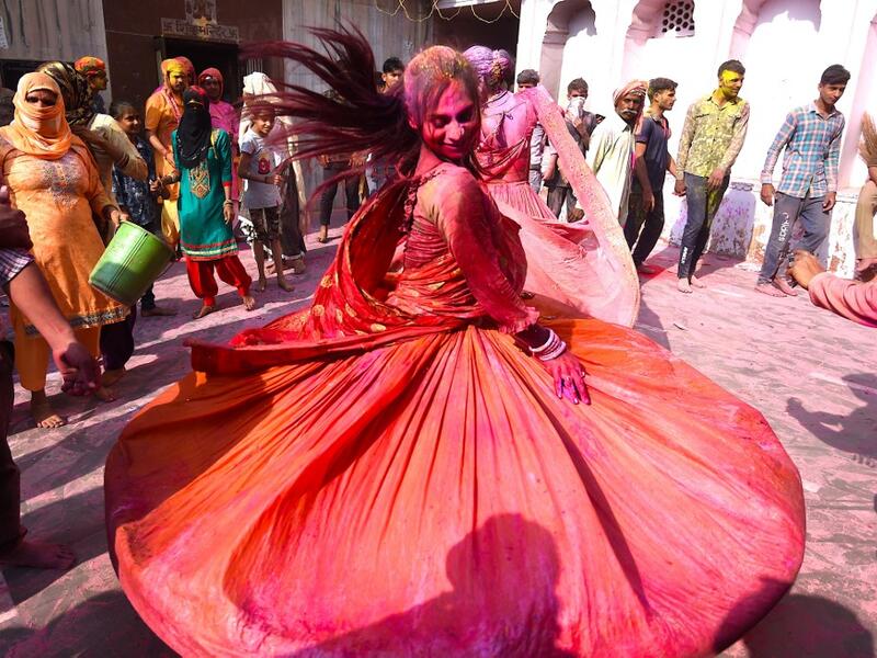 A Hindu devotee dances during Holi celebrations, the spring festival of colours, during a traditional gathering at a temple in Nandgaon village in Uttar Pradesh state on March 5, 2020. Holi is observed in India at the end of the winter season on the last full moon of the lunar month. Money SHARMA / AFP