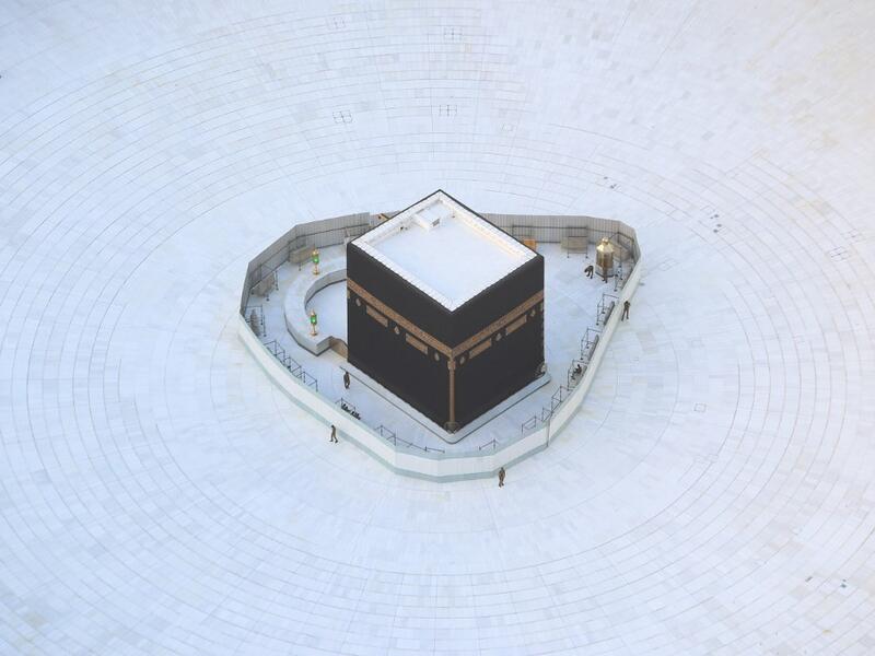 An aerial view shows an empty white-tiled area surrounding the Kaaba in Mecca's Grand Mosque, on March 6, 2020. An eerie emptiness enveloped the sacred Kaaba in Mecca's Grand Mosque, Islam's holiest site, where attendance at Friday prayers was hit by measures to protect against the deadly new coronavirus. Bandar ALDANDANI / AFP