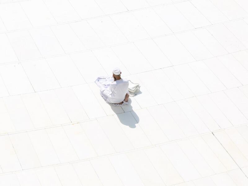 A Muslim worshipper prays near the sacred Kaaba in Mecca's Grand Mosque, Islam's holiest site, on March 7, 2020. Saudi Arabia reopened today the area around the sacred Kaaba, reversing one of a series of measures introduced to combat the coronavirus outbreak. Saudi authorities this week suspended the year-round umrah pilgrimage, during which worshippers circle the Kaaba seven times, and also announced the temporary closure of the area around the cube structure.  Abdel Ghani BASHIR / AFP