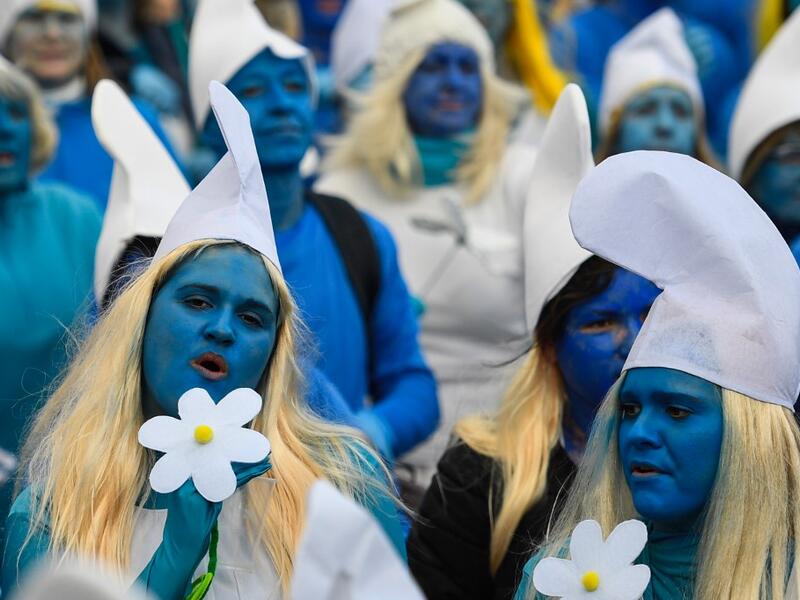 People dressed as Smurfs ('Schtroumpfs' in French), a Belgian comic franchise centered on a fictional colony of small, blue, human-like creatures who live in mushroom-shaped houses in the forest, attend a world record gathering of Smurfs on March 7, 2020, in Landerneau, western France. Damien MEYER / AFP