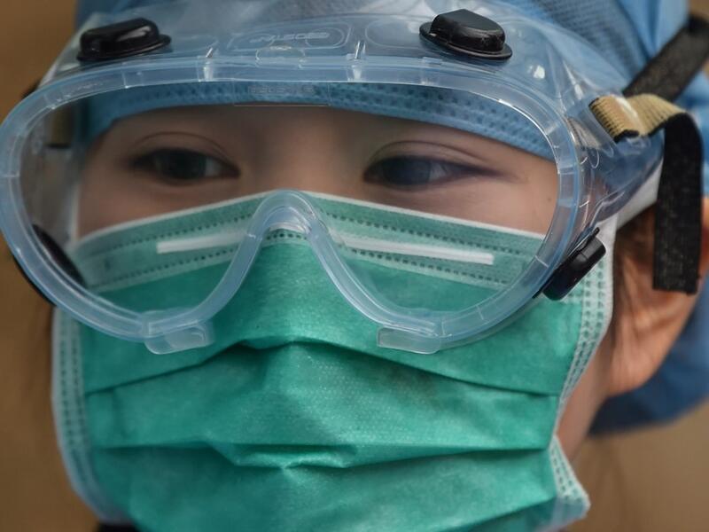 A medical worker wearing protective clothing as a preventive measure against the COVID-19 coronavirus, stands at Xuhui District Hospital in Shanghai on March 9, 2020 China reported 22 new deaths on March 9 from the new coronavirus epidemic, and the lowest number of fresh cases since it started reporting the data in January. Hector RETAMAL / AFP