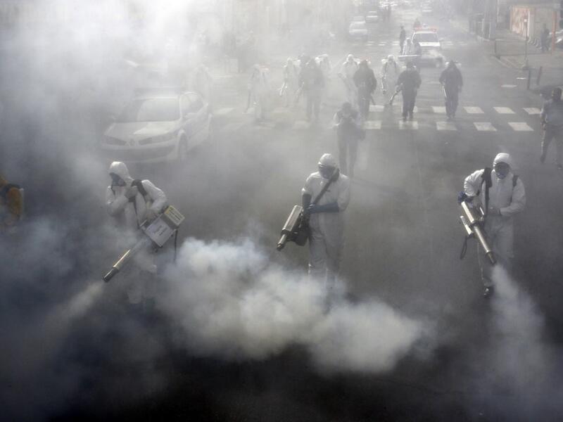 Iranian Firefighters disinfect streets in the capital Tehran in a bid to halt the wild spread of coronavirus on March 13 2020. Iranian forces will clear the streets nationwide within 24 hours and all citizens will be checked for the new coronavirus in a bid to halt its spread, the military said. AFP