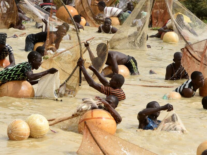 Fishermen try to catch fishes during the final of the revived Argungu fishing and cultural festival at Argungu Town, Kebbi State in northwest Nigeria, on March 14, 2020. Argungu fishing and cultural festival is one of the oldest and most widely attended festivals in the country dating back many generations, featuring series of water competitions and traditional games. The festival returned after 10 years suspension due to insecurity in northwest Nigeria. PIUS UTOMI EKPEI / AFP