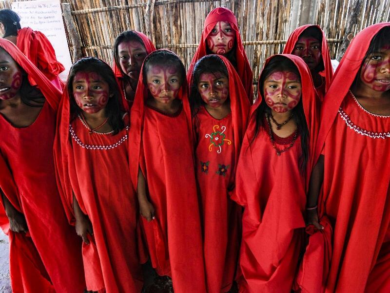 Wayuu girls prepare to perform the traditional La Yonna dance, in Tres Bocas, northern Colombia, on March 13, 2020. Juan BARRETO / AFP