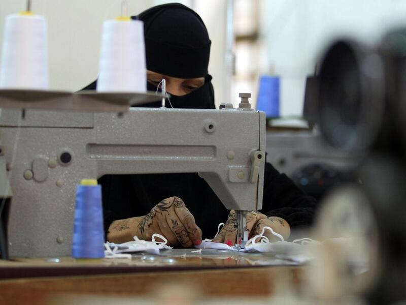Yemeni women make face masks at the textile factory in the capital Sanaa on March 16, 2020. Yemen's Huthi rebels said they would suspend passenger flights in and out of Sanaa airport for two weeks to prevent the introduction of novel coronavirus. The country has not to date announced any cases of the COVID-19 illness, but the poor state of the country's health infrastructure after five years of war would mean that such an outbreak could be catastrophic.  MOHAMMED HUWAIS / AFP