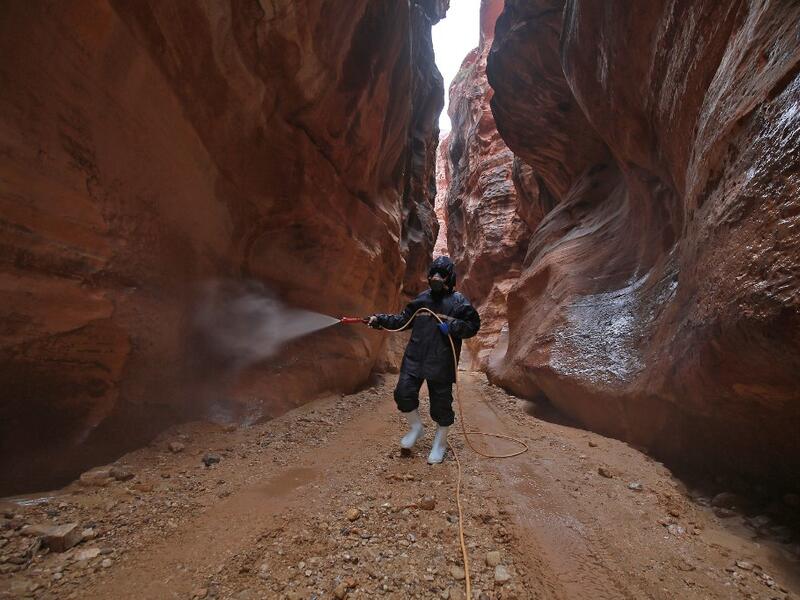 A labourer sprays disinfectant in Jordan's archaeological city of Petra south of the capital Amman on March 17, 2020, to prevent the spread of COVID-19. Khalil MAZRAAWI / afp