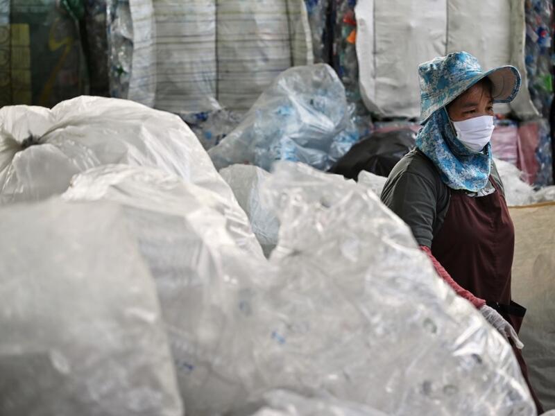 A Buddhist devotee sorts salvaged plastic bottles to be recycled into monks’ robes and face masks, amid concerns over the spread of the COVID-19 coronavirus, at Wat Chak Daeng Buddhist temple in Samut Prakan on March 23, 2020. The plastic wastes are sent to a separate recycling facility processing it into thread materials and woven as special fabric for monks. Lillian SUWANRUMPHA / AFP